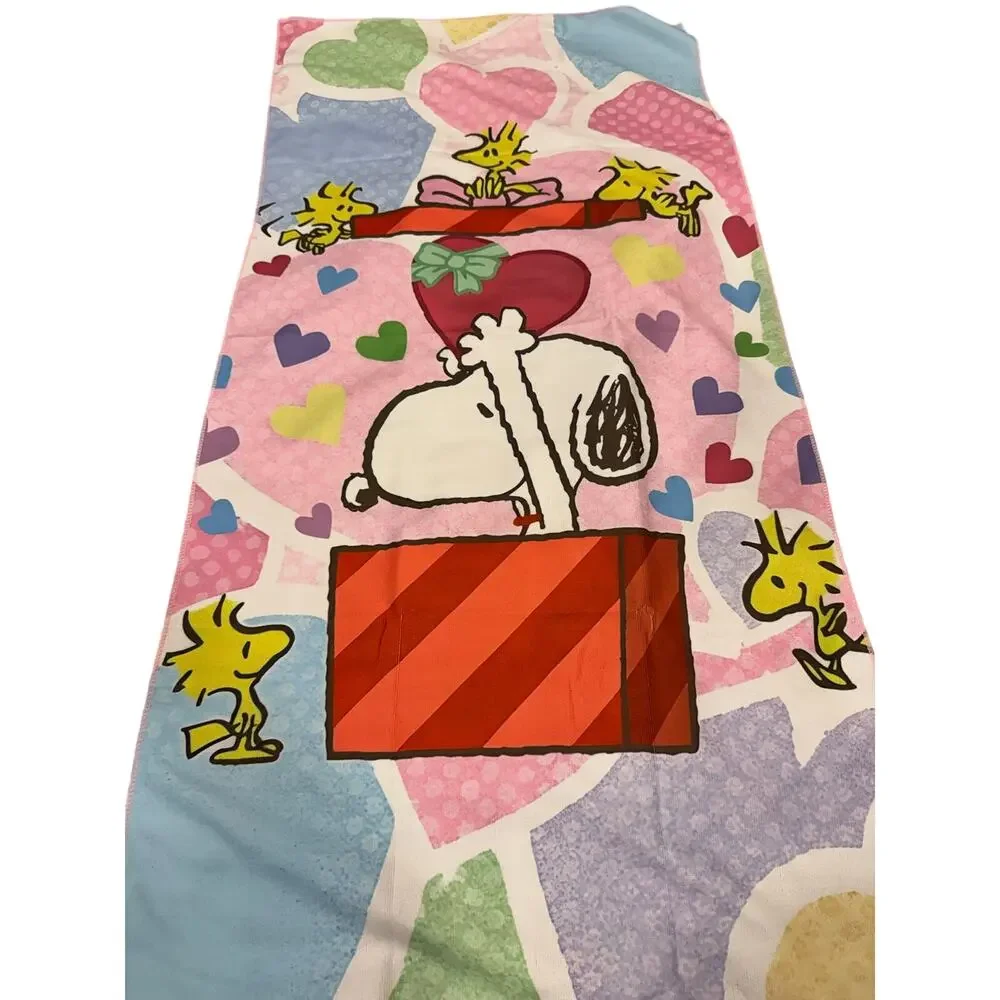 Snoopy peanuts come out of a present beach towel